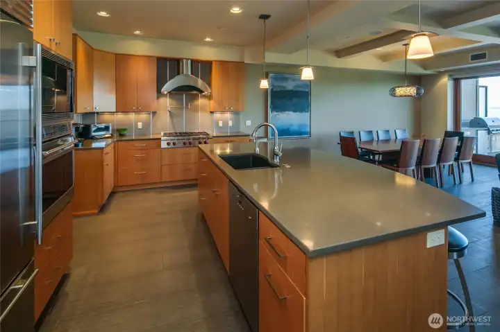 Another view of the kitchen with the Wolf 6 burner cooktop, the Miele wall oven and microwave and the Sub Zero refrigerator.