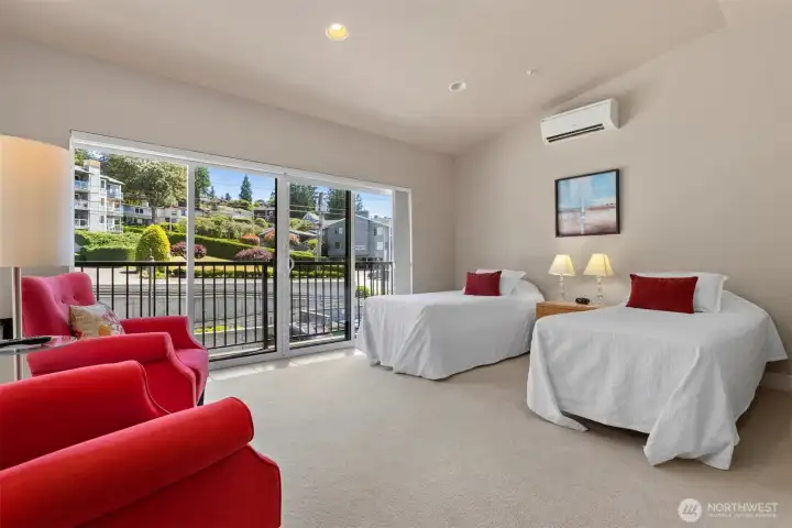The guest suite to the North has twin beds and a glass sliding door that opens to a small Juliet-type deck.