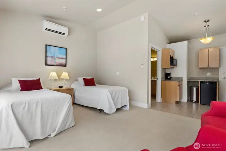 Looking across the twin bed suite toward the kitchenette and the 3/4 bath beyond.
