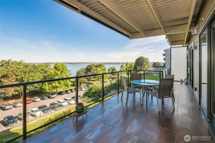 Looking toward the North from the spacious and covered deck. There is a roll-down shad to keep the sun out concealed above. This views are of the harbor, bay, Canadian Mountains, city of Bellingham and you get to hear the hustle and bustle of the happy people at Boulevard Park!