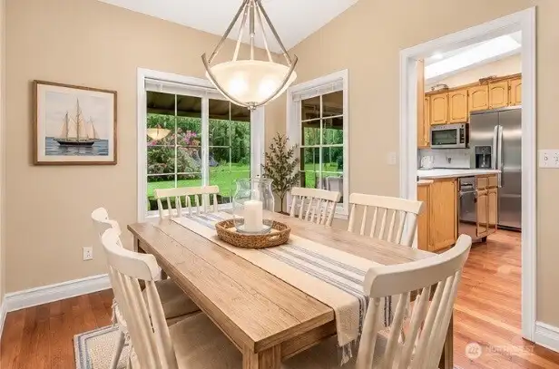 Dining Room to kitchen, main level  *virtually staged