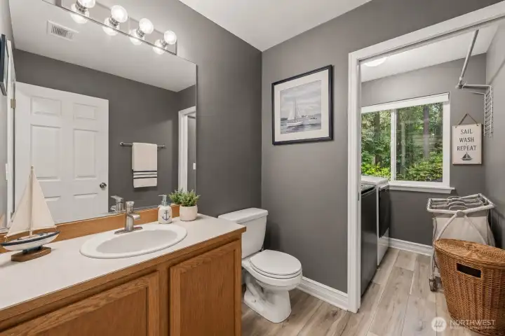 Guest bathroom 1 and laundry room, lower level  *virtually staged