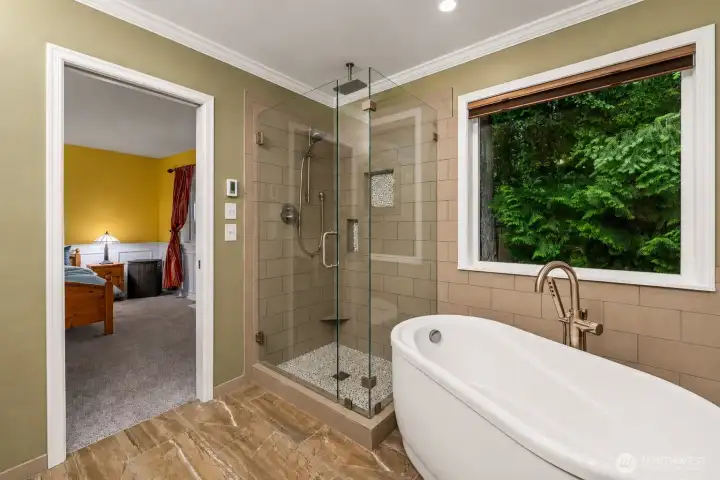 Master bath with seperate tub, shower, heated floor and towel racks.