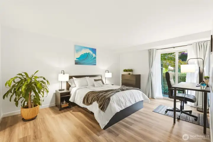 Spacious Primary Bedroom with a door leading into the patio. Sliding glass door is new. Spacious Primary Bedroom with a door leading into the patio. Sliding glass door is new.