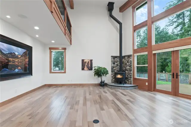 Open floor plan with the wood stove and super tall ceilings.