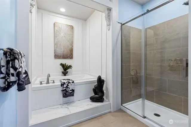 Step into the double size tile and glass shower, or opt for a spa moment in the deep soaking tub, ready to melt away the cares of the day in this primary suite bathroom.