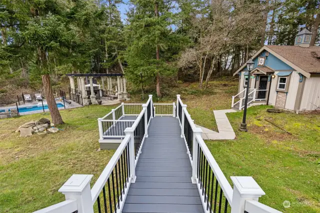 Decking extends to railed walkways to all of the additional backyard amenities! With 2.36 acres that backs up to a 200ft buffer that can’t be built on for added privacy!