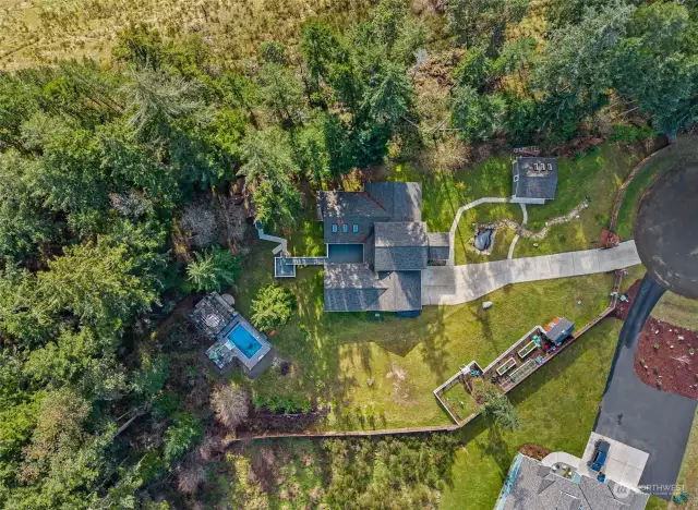 While you enjoy all of the benefits of a gated multi-acre estate, you are still close enough to neighbors to not feel totally isolated, a rare find in today’s market!  There is garden shed, garden, detached garage, main house with attached 2-car garage, pub/extra finished building, 2 pools and a hot tub.