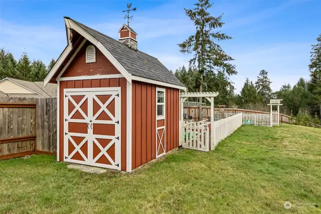 The gardener in your life wil adore this barn-style garden shed with rooster weathervane next to the fully fenced white picket garden that has three raised beds ready for your spring plantings! There is a newer John Deere riding mower that is negotiable too.