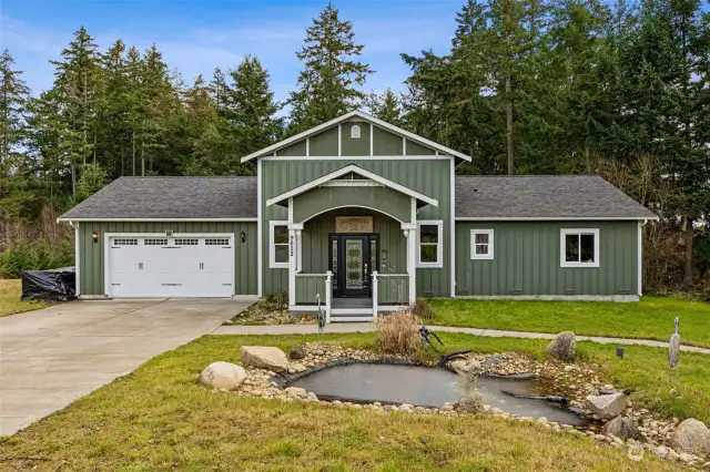 The wide, level driveway leads to a carriage-style 2-car garage with automatic opener just steps from the covered front porch.  The board and batten style Hardi-plank siding gives durable peace of mind, and the welcoming front porch is a nice place to greet guests as they come and go.  Just inside the grand foyer features a stunning leaded glass front door and artistically laid tile floor under soaring 10ft ceilings.  This is a spacious and welcoming start to this well-appointed home.