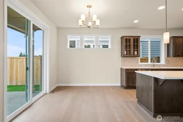Dining nook with transom windows for added light and an oversized slider to backyard
