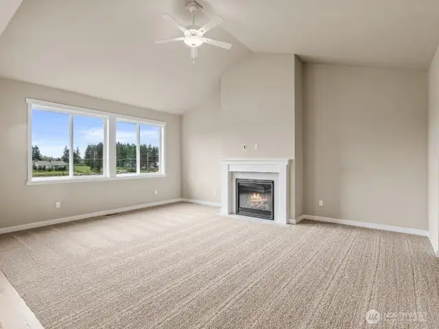 Lovely, vaulted ceilings in living room. Ceiling fans are standard in living rooms and primary bedroom