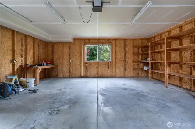 2 car garage with built-in shelves and work table