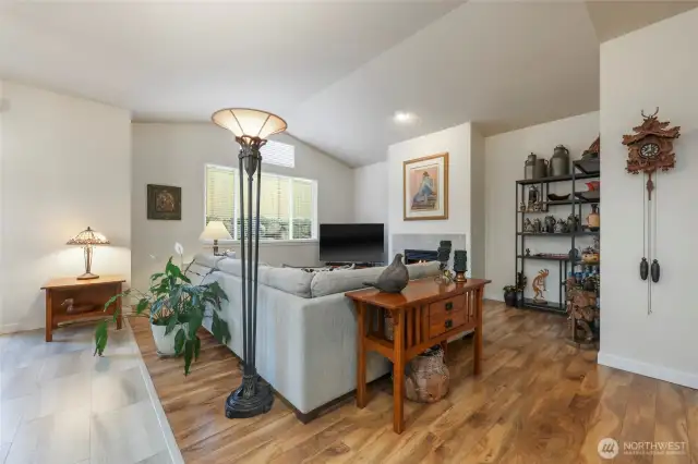 Cozy living area with vaulted ceilings ...