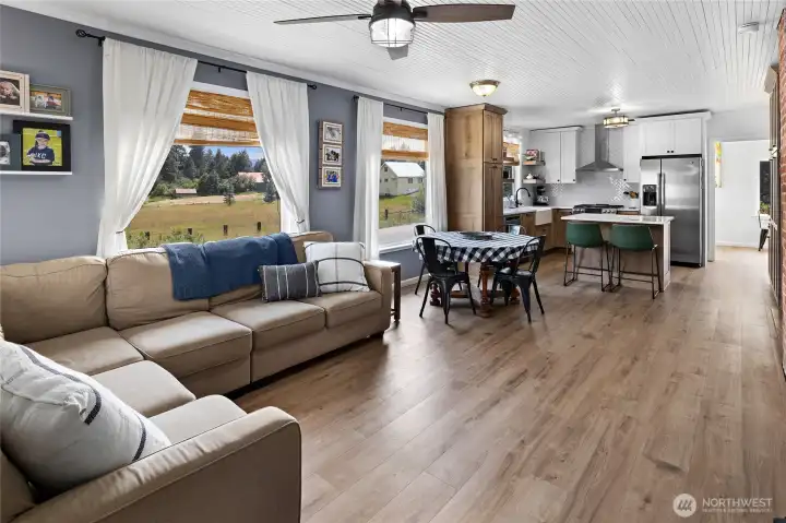 Spacious living area showcases new Luxury Vinyl Plank flooring. Pretty & Practical!