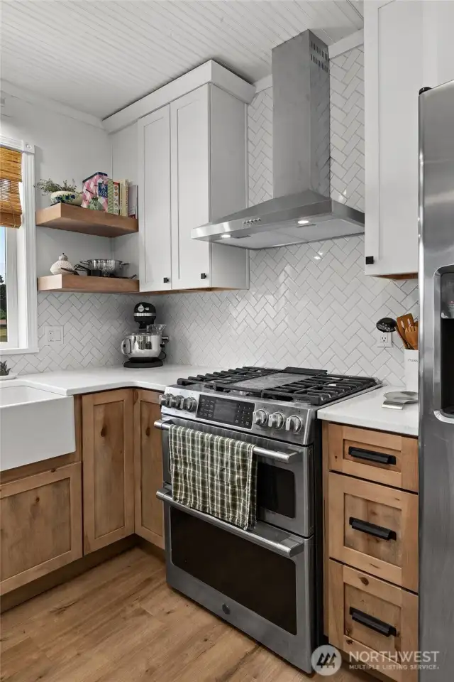 GE Cafe' Series propane range with double ovens, & new trendy vent hood too.