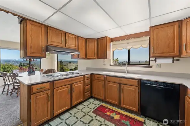 Kitchen with updated counters, double oven and stainless appliances.