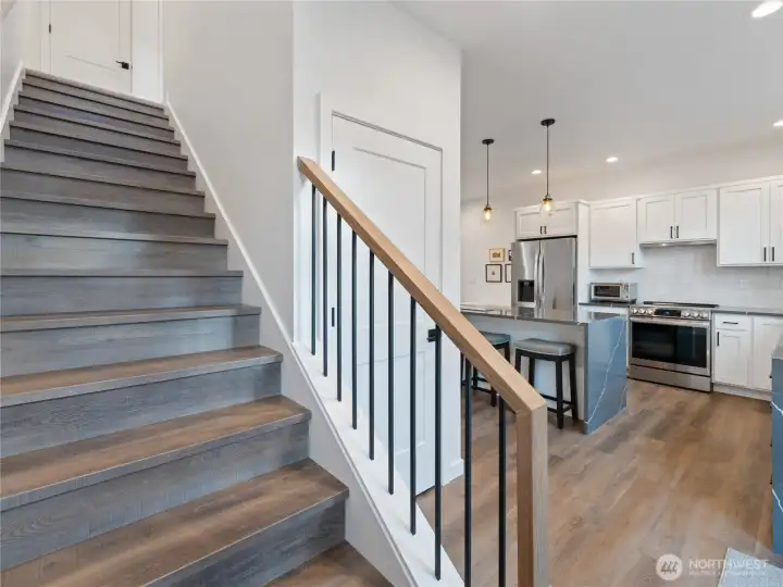 LVP stairs leading upstairs to the additional 2 bedrooms and full bath.