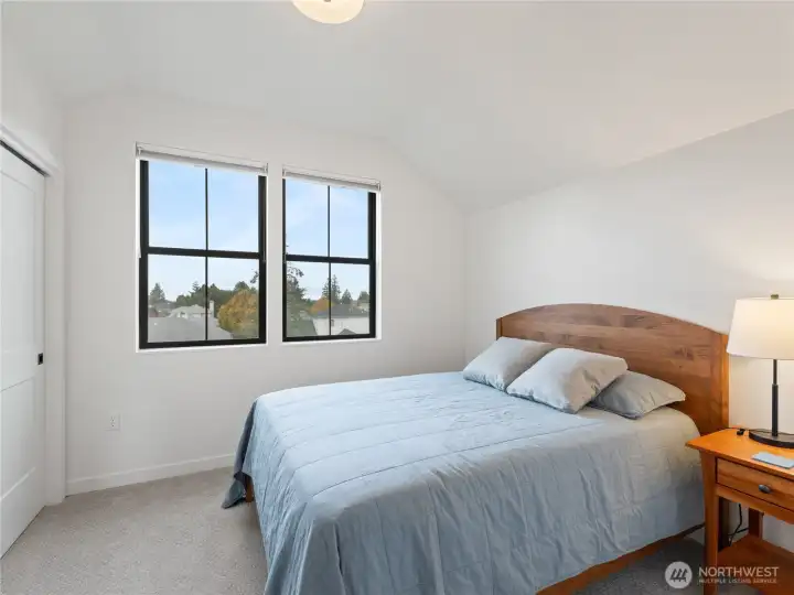 Upstairs bedroom overlooks the open space and pond.