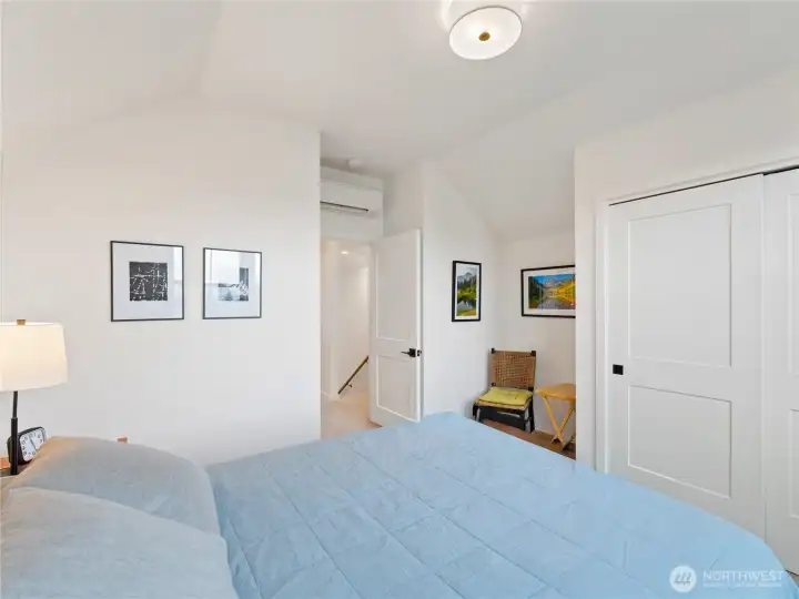 View from the upstairs bedroom out to landing of the stairs and hallway. Convenient nook is perfect for a desk or seating.