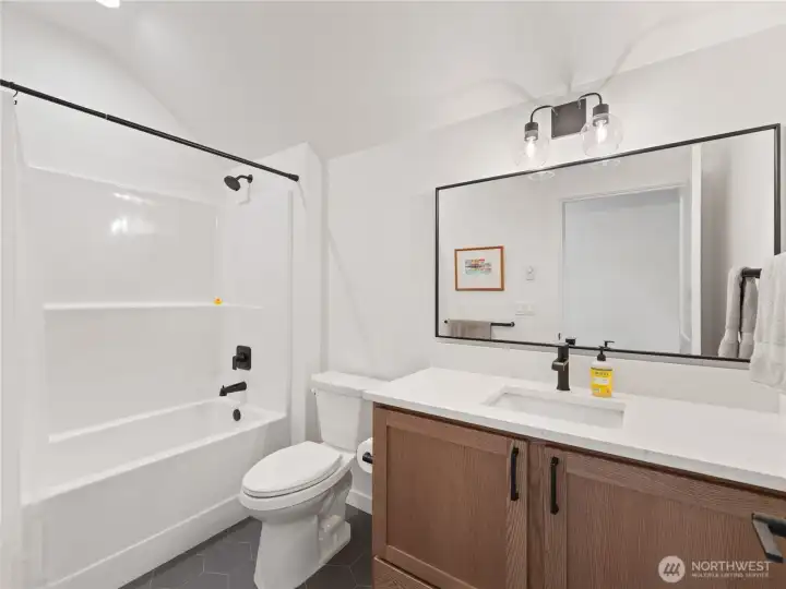 Upstairs additional full bathroom with tub/shower and tile floors.