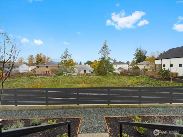 Looking out to the fenced in pond area with walking path.