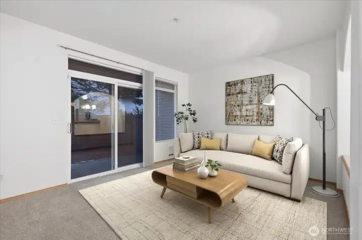 Living area with slider to private patio and fenced yard. Virtually staged.