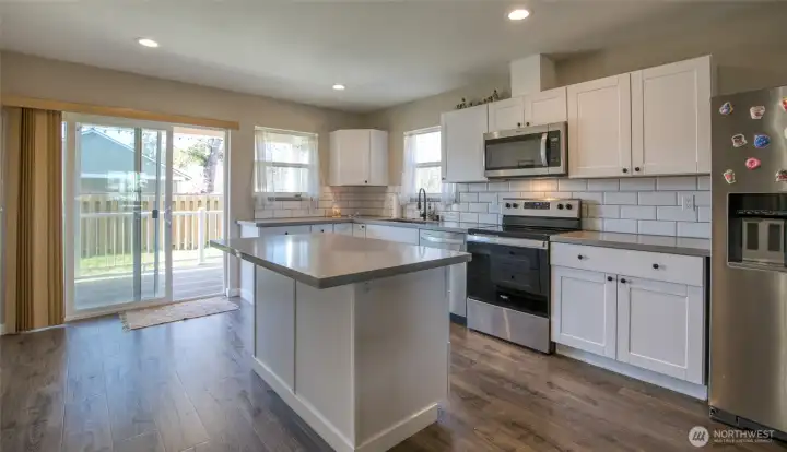 Well appointed kitchen with island and quartz countertops