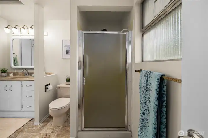 Freestanding shower offering style, comfort, and easy access.