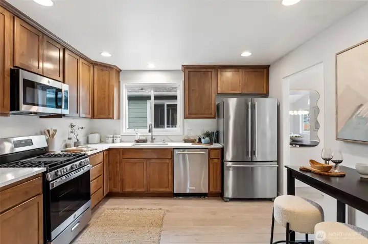 The refreshed kitchen features beautiful crushed quartz counters, a new sink and faucet.