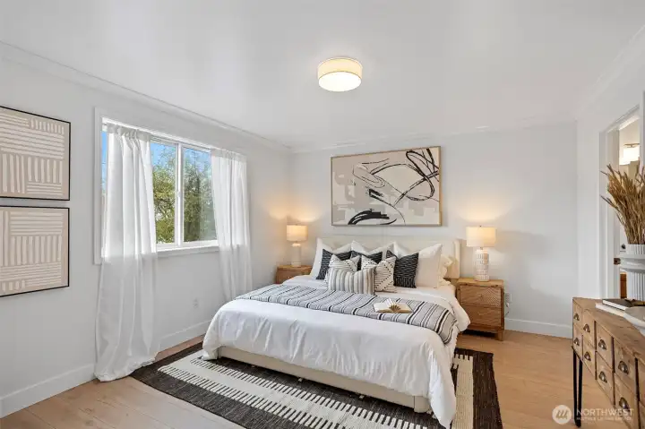 The spacious primary suite overlooks the private backyard and patio.