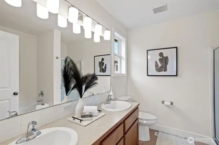 The primary en-suite bath features a large soaking tub and separate shower, it boasts an extra long vanity with 2 sinks.