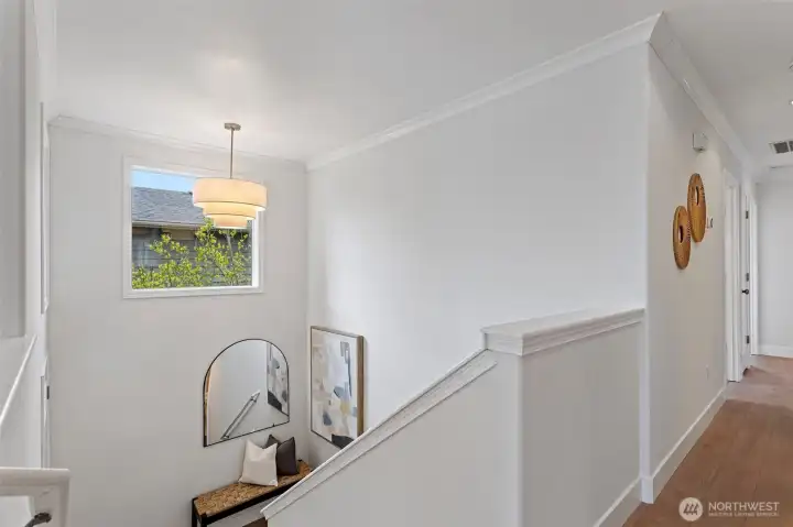 New luxury vinyl plank flooring covers the extensive entry and stairs, a statement chandelier gives this entry the final touch.