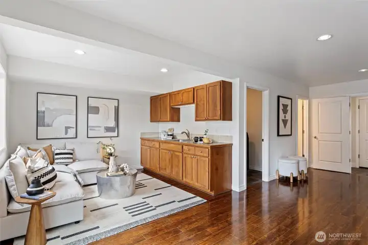 Relax in this spacious lower level rec room with partial kitchen, how convenient.  There is a range plug-in should someone want a full kitchen.