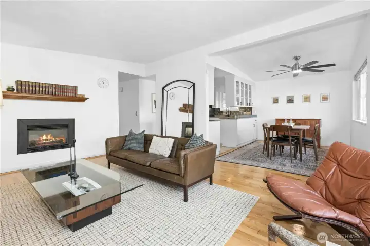 Living room opens to dining and kitchen with classic MCM pitched ceiling!