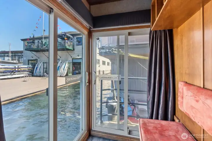 This is the Primary bedroom with access to the water through two slider doors, with one leading to a deck and ladder access to get back onboard after a moring swim...