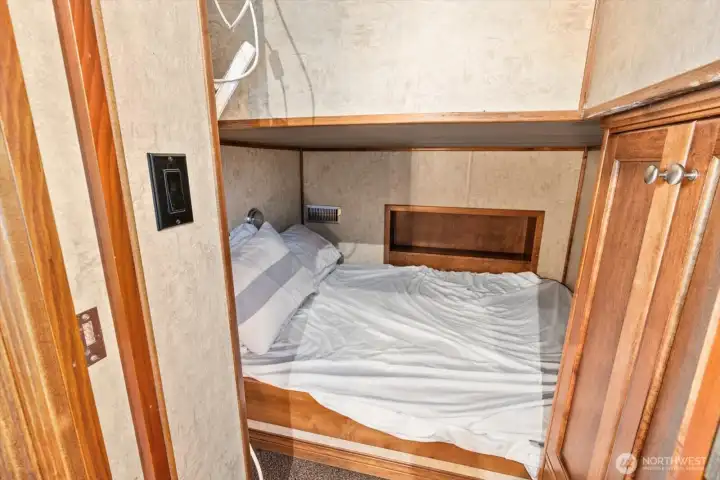 One of two lower level queen bed sleeping births.
