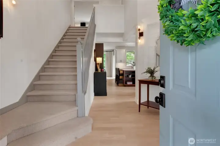 Step through the front door into a two-story foyer filled with natural light and wide plank flooring throughout the main level.