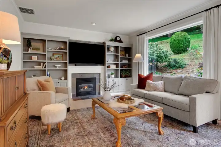 Adjacent to the kitchen sits an inviting yet comfortable family room with a cozy fireplace banked by built-in bookcases.
