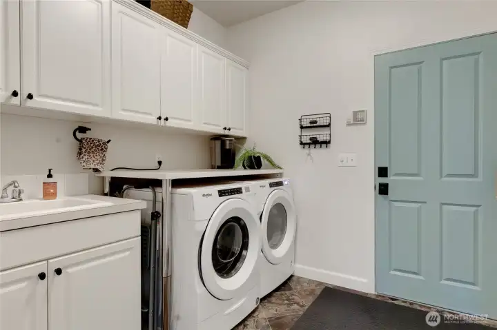 A dreamy laundry/mudroom has so much storage space for your household items and a laundry tub for easy clean up jobs.