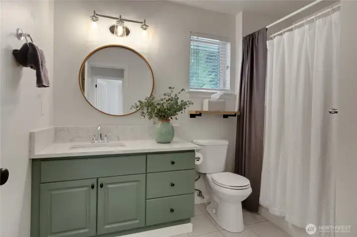 Well dressed full bath services bedrooms two and three nicely.