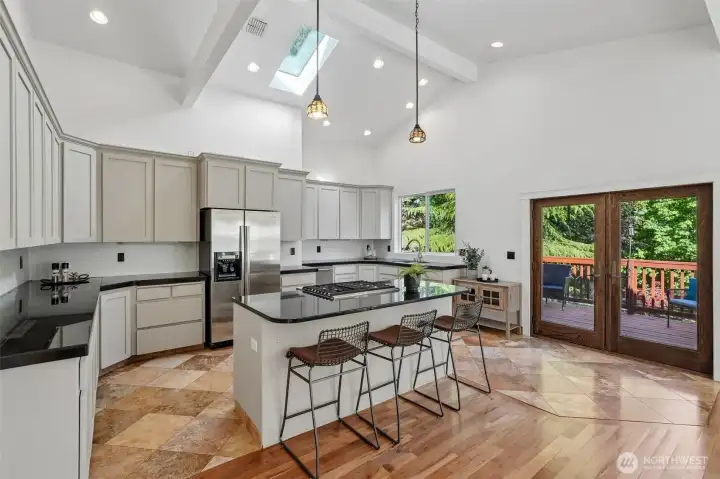 Kitchen & Dining areas, eating island, Hardword & tile floors, vaulted ceilings, French doors to 2nd deck, skylights