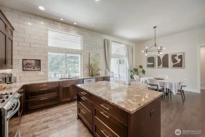 A gas range, spacious storage & massive island making cooking a joy.