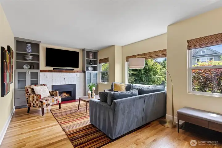 The living room is bright and spacious with south-facing light, a gas fireplace flanked by custom built-ins, and a warmth that makes you want to stay. The living room is bright and spacious with south-facing light, a gas fireplace flanked by custom built-ins, and a warmth that makes you want to stay.