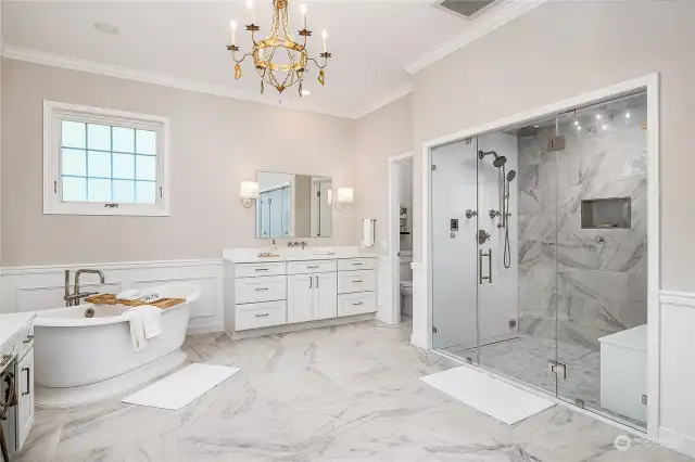 This spa like bathroom has been updated with Italian porcelain tile, heated floors, a steam shower, two vanities, soaking tub and two closets with built-in organization.