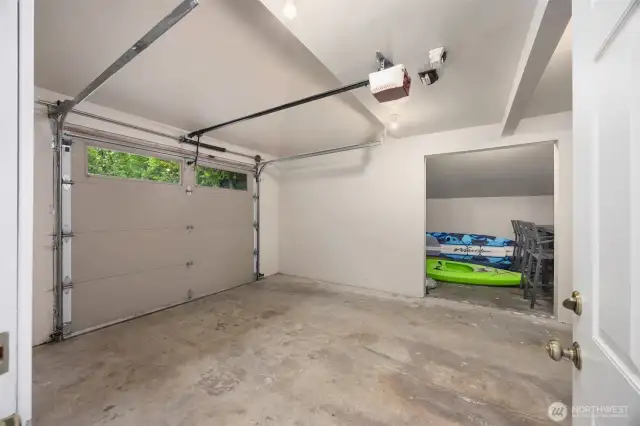 Attached single car garage with storage on the side.
