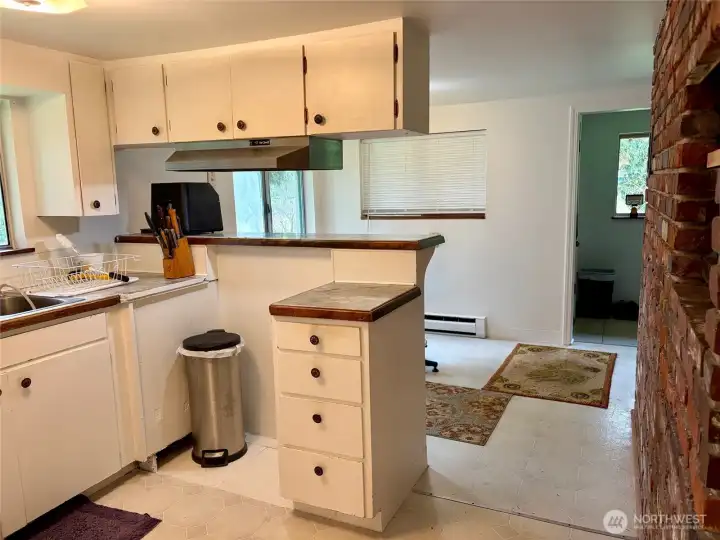 Kitchen, eating space and entry in the distance