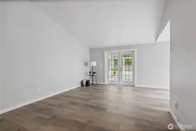 Great room leads to back enclosed porch.