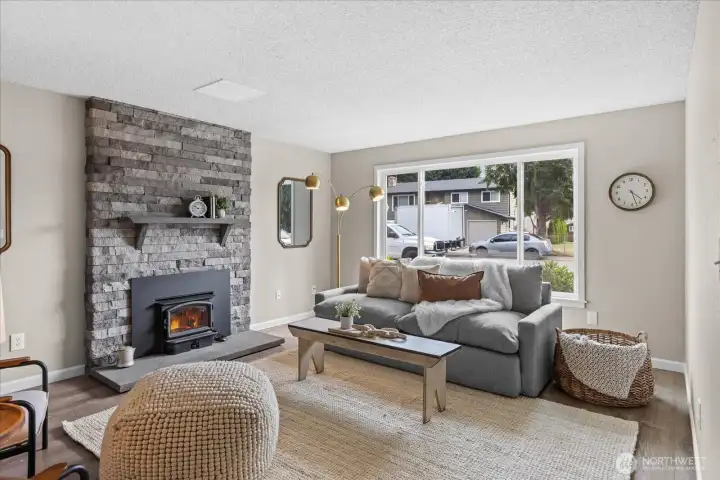 Appreciate the stunning stone fireplace and mantle with a wood burning stove.