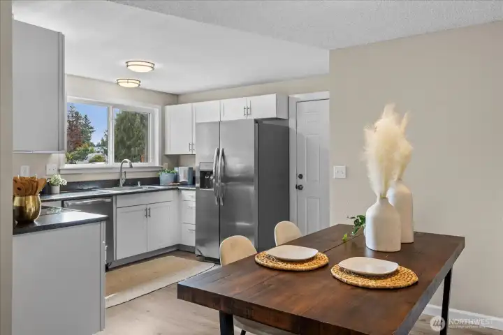 Kitchen offers SS appliances, newer cabinets, counters and lighting PLUS easy access to garage!